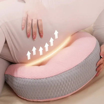  A pregnant woman comfortably resting with a C-shaped pregnancy pillow, designed to provide full-body support for the belly, lower back, and hips. Made from breathable, hypoallergenic fabric, this ergonomic pillow promotes healthy posture, reduces pressure on the spine, and enhances sleep quality. Perfect for sleeping, lounging, or postpartum nursing.